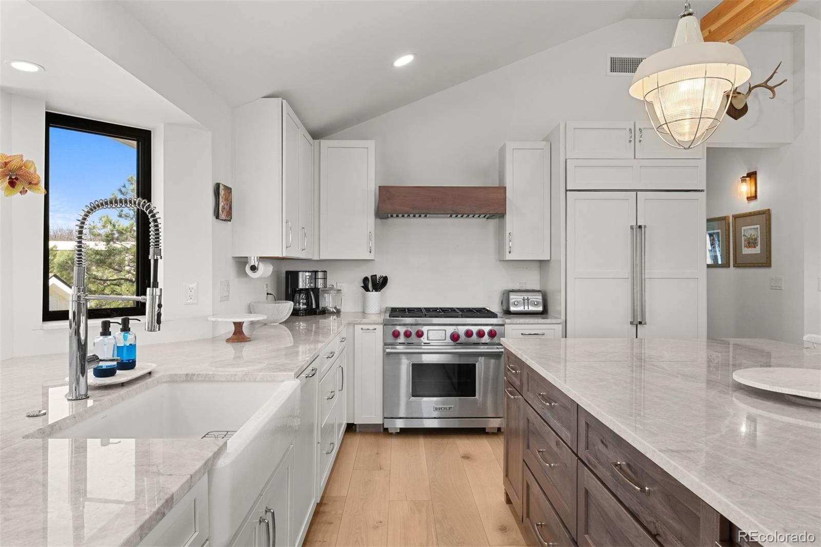 3303 West Wolfensberger Road Sedalia, CO 80135 - Photo 14 of 36 a kitchen with stainless steel appliances granite countertop a sink stove and refrigerator