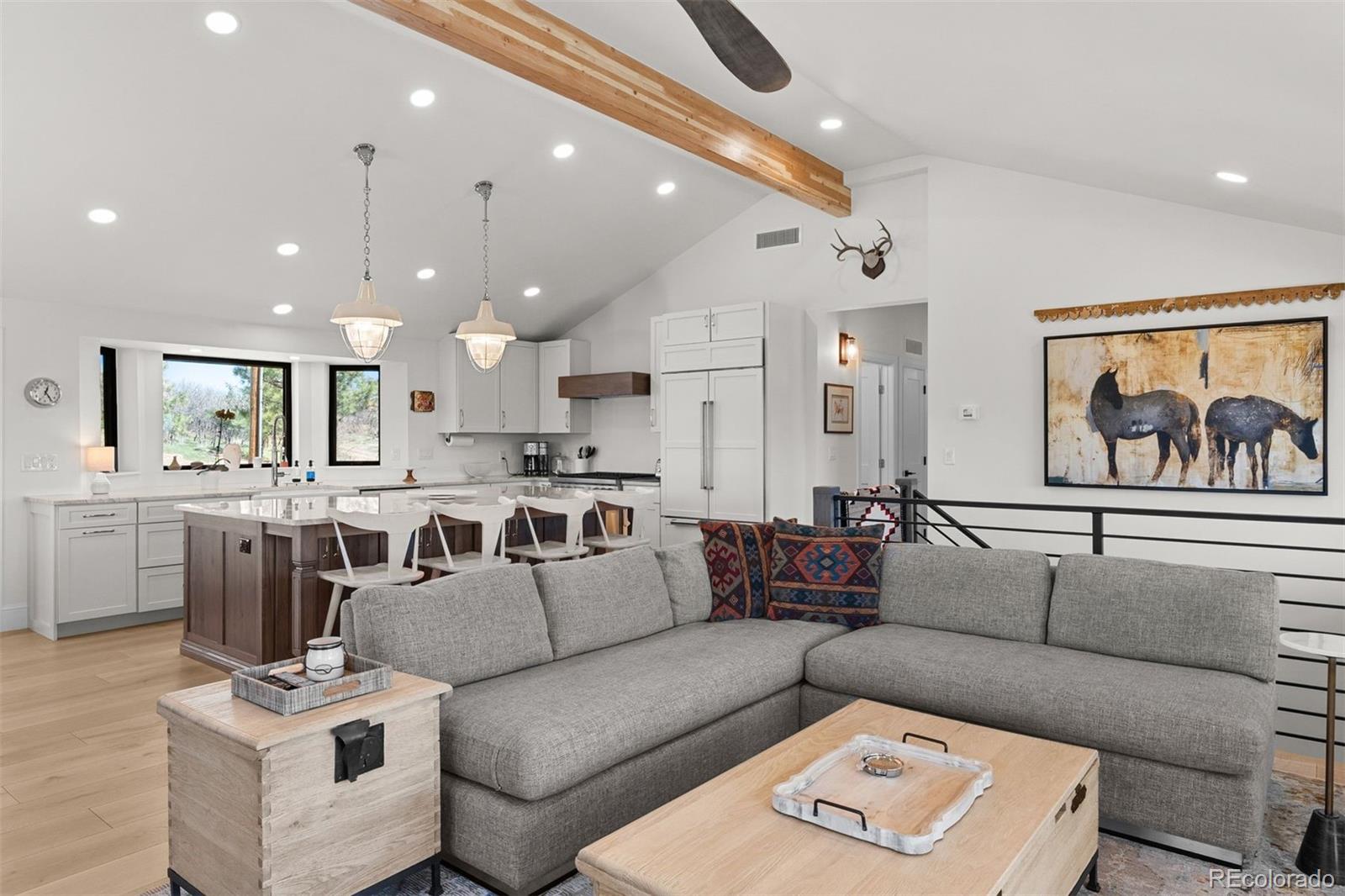 3303 West Wolfensberger Road Sedalia, CO 80135 - Photo 21 of 36 a living room with furniture and a large window