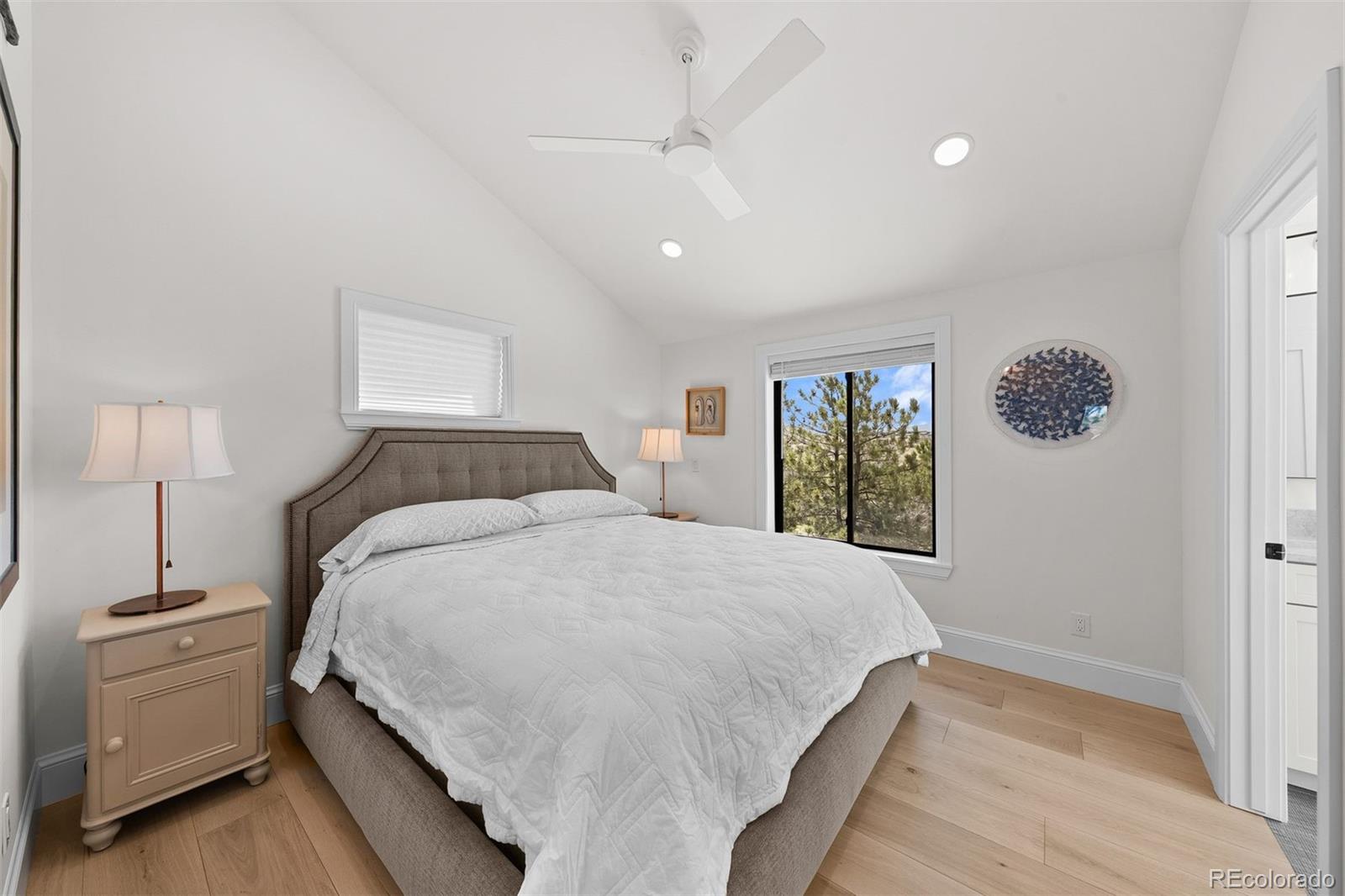 3303 West Wolfensberger Road Sedalia, CO 80135 - Photo 22 of 36 a bedroom with a large bed and a window