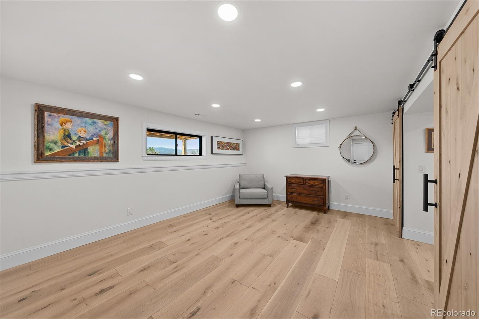 3303 West Wolfensberger Road Sedalia, CO 80135 - Photo 28 of 36 a view of a room with wooden floor and window