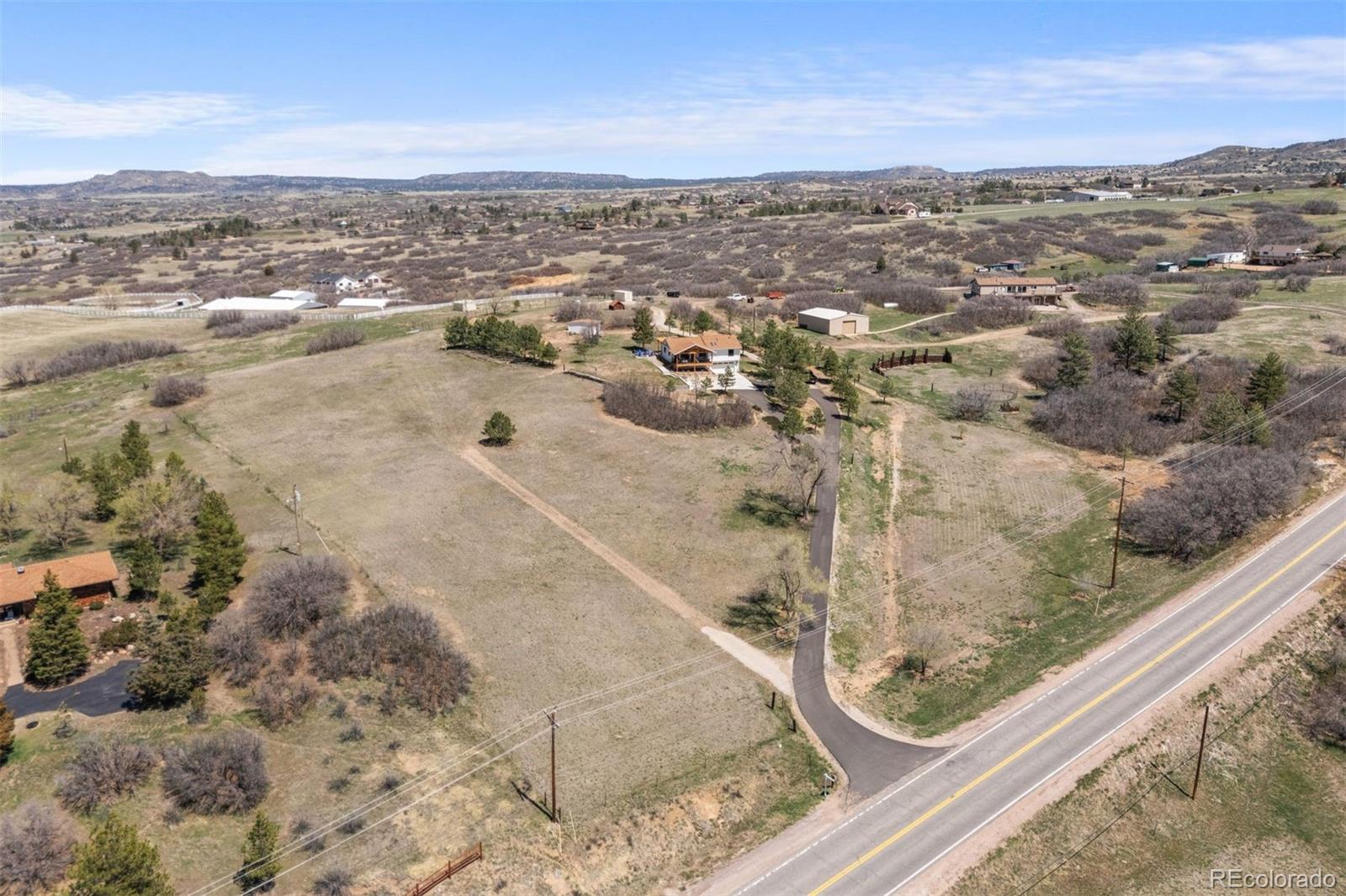 3303 West Wolfensberger Road Sedalia, CO 80135 - Photo 33 of 36 an aerial view of residential houses with outdoor space