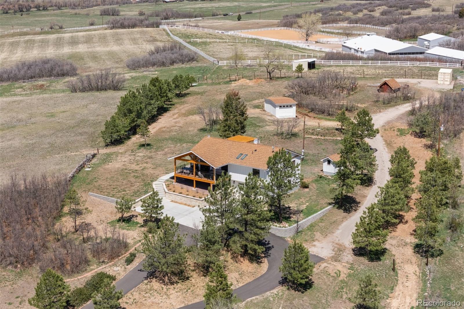 3303 West Wolfensberger Road Sedalia, CO 80135 - Photo 34 of 36 an aerial view of residential houses with outdoor space