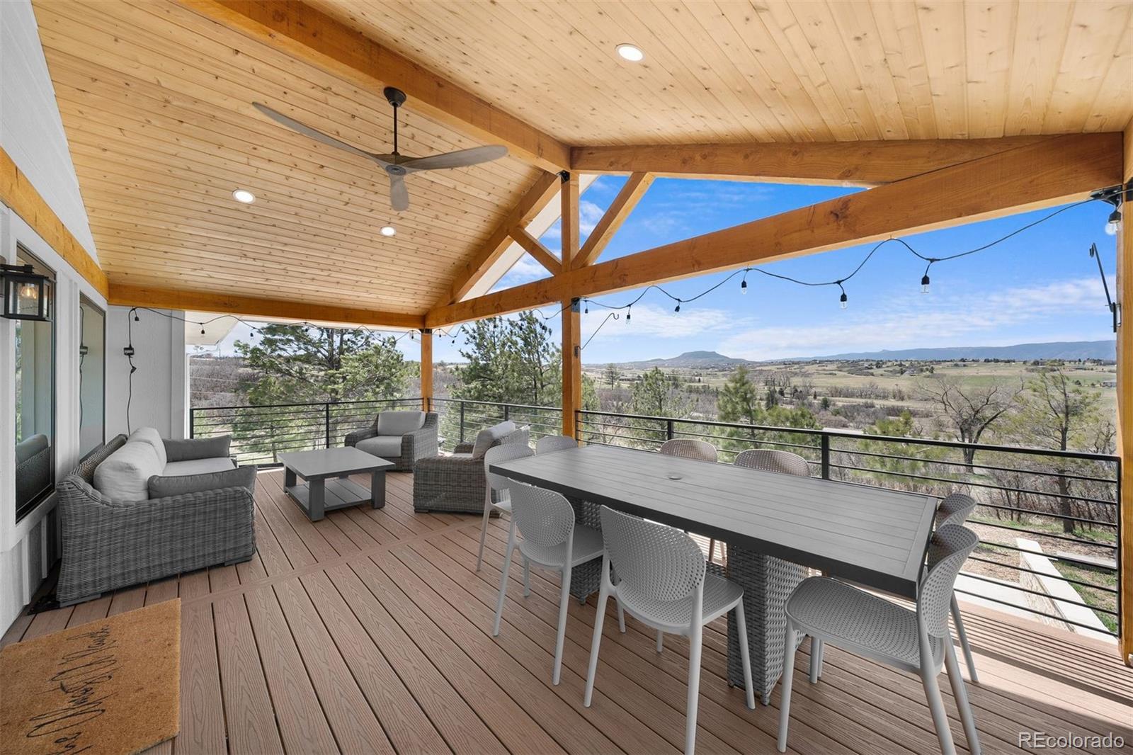 3303 West Wolfensberger Road Sedalia, CO 80135 - Photo 6 of 36 a view of a roof deck with couches and potted plants