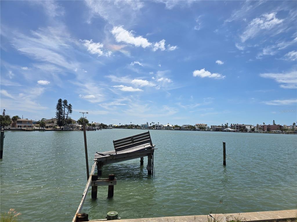 a view of a lake with a table and chair