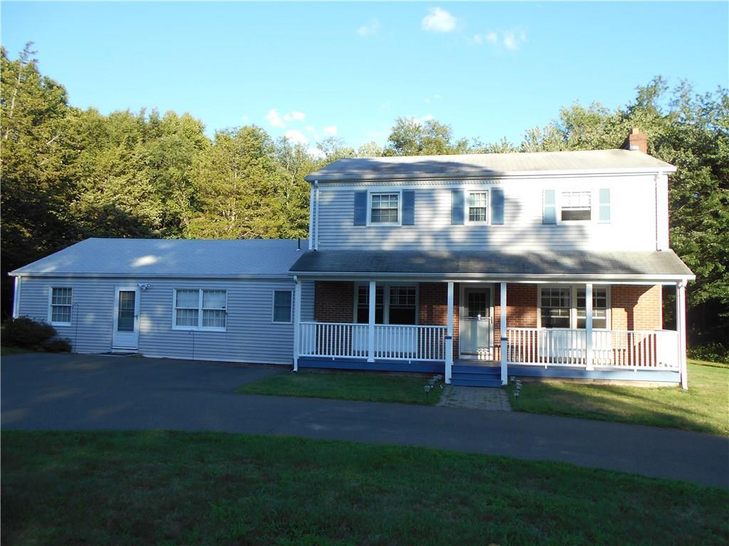 a front view of a house with a garden and yard