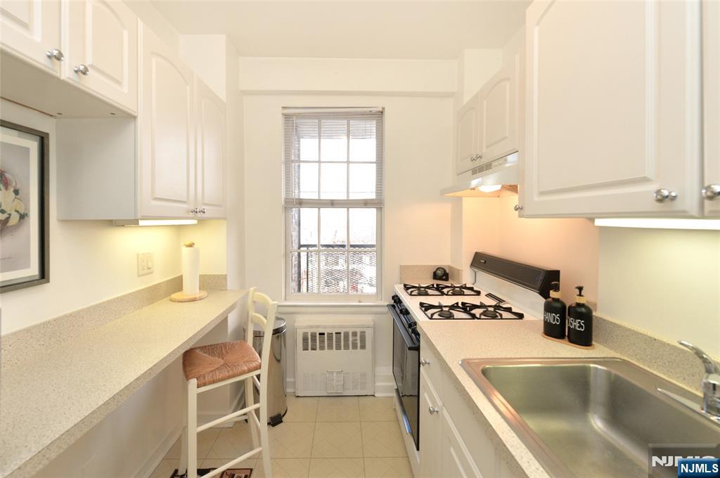 5 Roosevelt Place, Unit 2B Montclair, NJ 07042 - Photo 3 of 20 a kitchen that has a sink and a stove in it