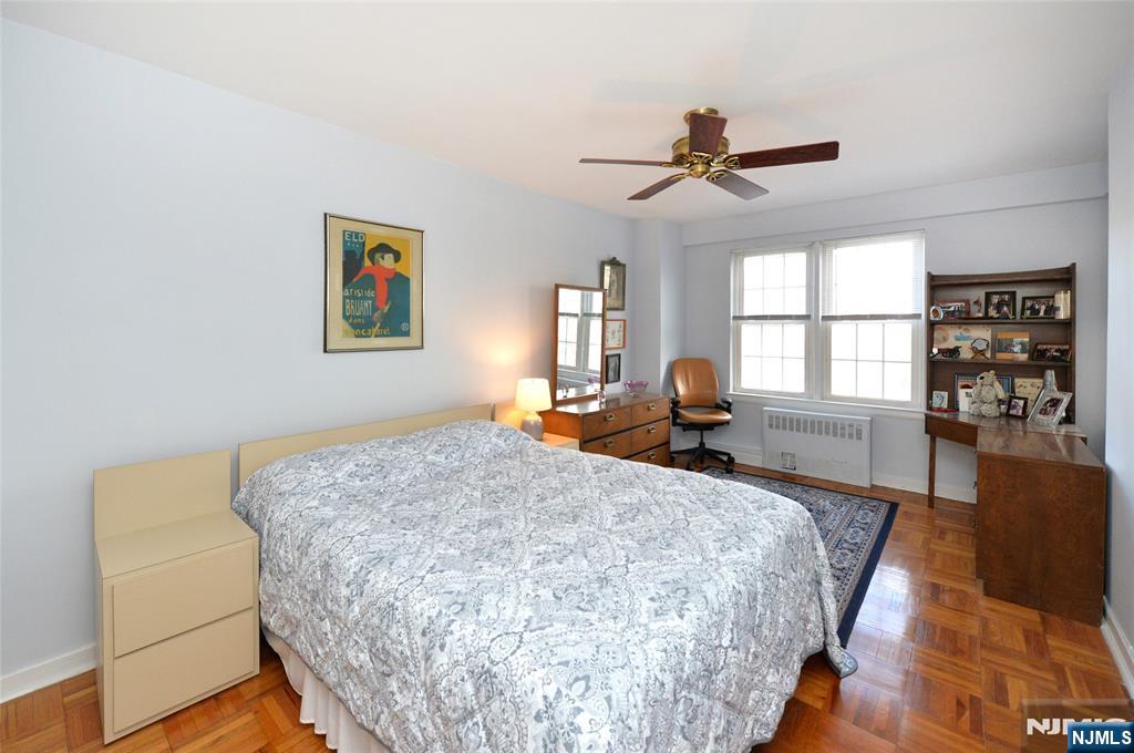 5 Roosevelt Place, Unit 2B Montclair, NJ 07042 - Photo 7 of 20 a bedroom with a bed and wooden floor