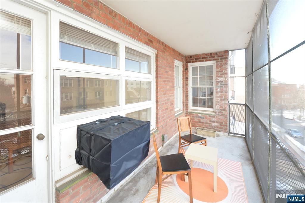 5 Roosevelt Place, Unit 2B Montclair, NJ 07042 - Photo 10 of 20 a living room with furniture and a large window