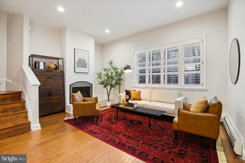 a living room with furniture a rug and a fireplace