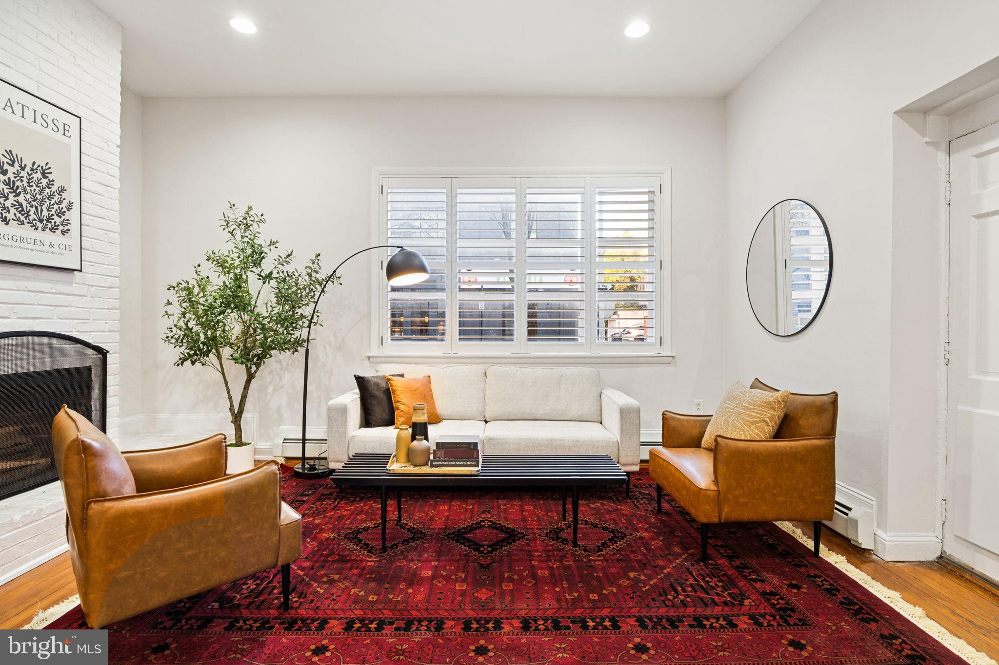 1238 Waverly Street Philadelphia, PA 19147 - Photo 5 of 24 a living room with furniture a rug a lamp and a large window
