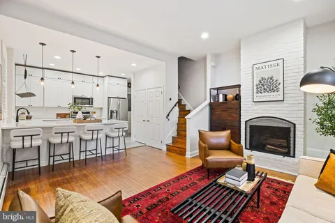 a living room with furniture a fireplace and a table