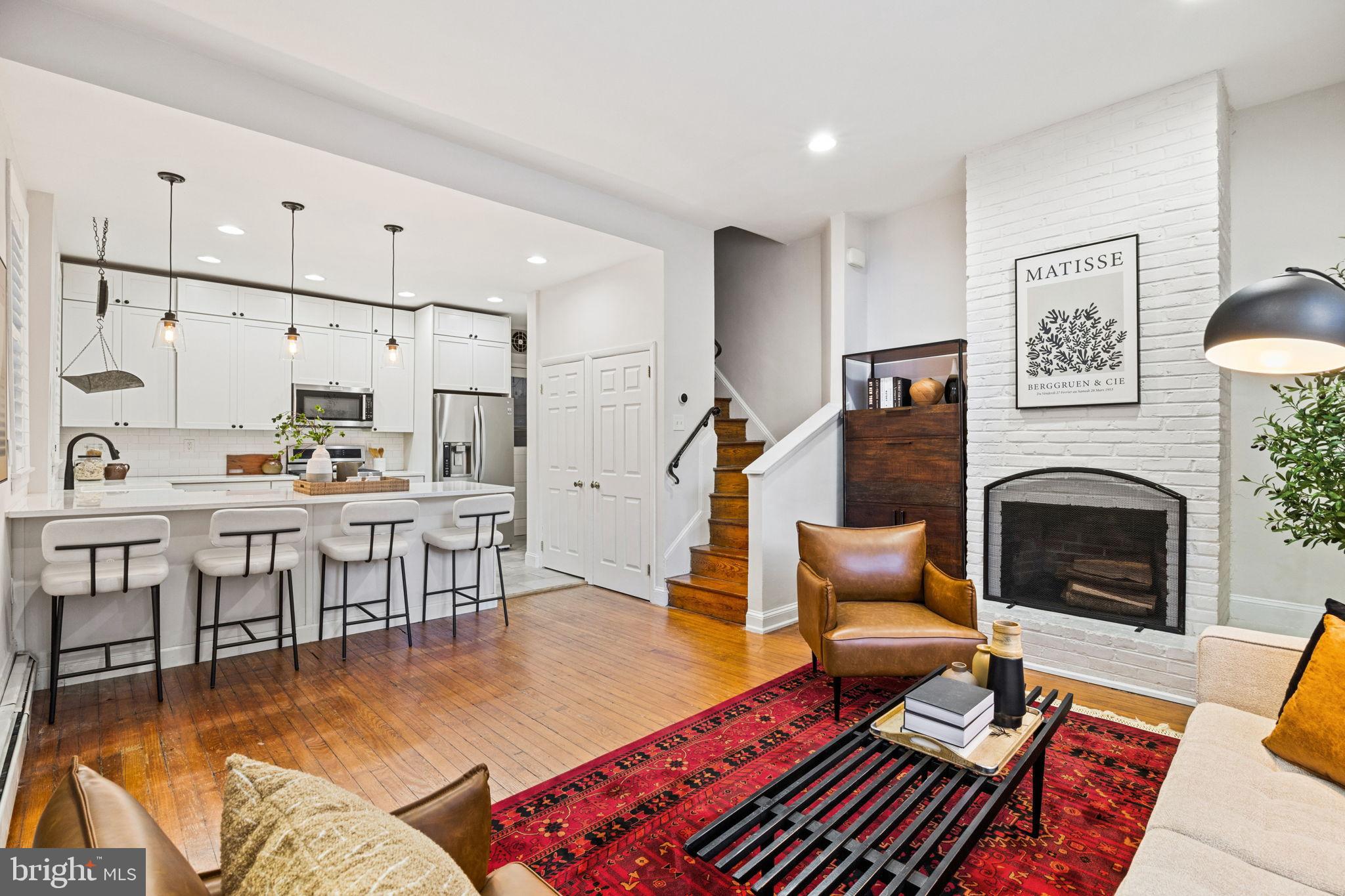 1238 Waverly Street Philadelphia, PA 19147 - Photo 6 of 24 a living room with furniture a fireplace and a table