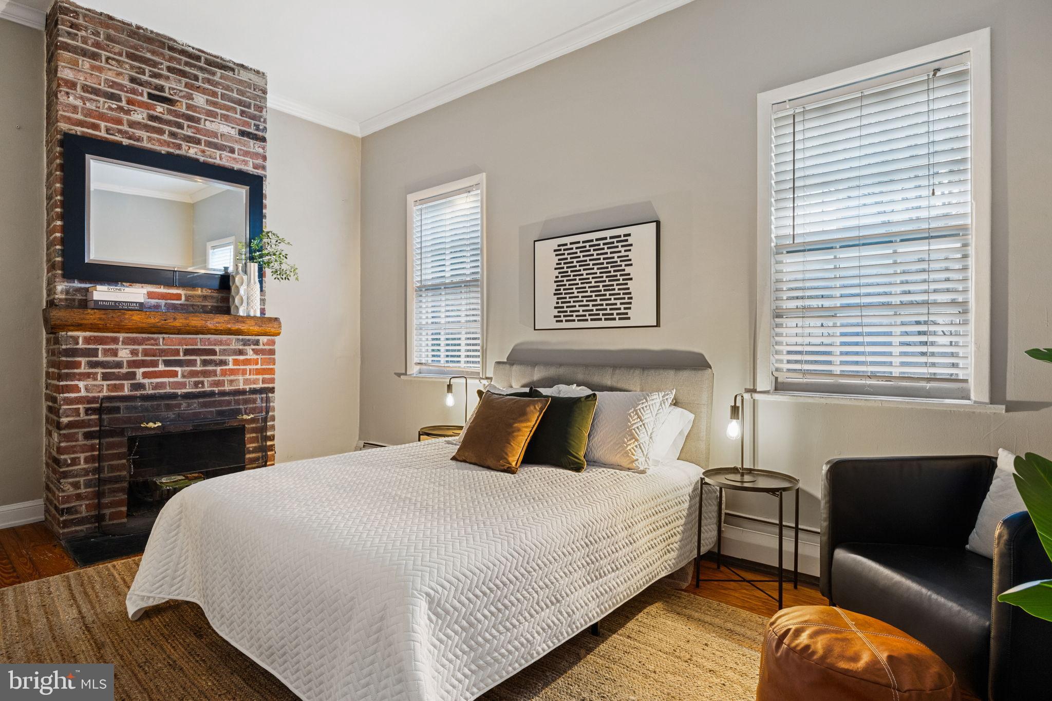 1238 Waverly Street Philadelphia, PA 19147 - Photo 7 of 24 a bedroom with bed and a fireplace