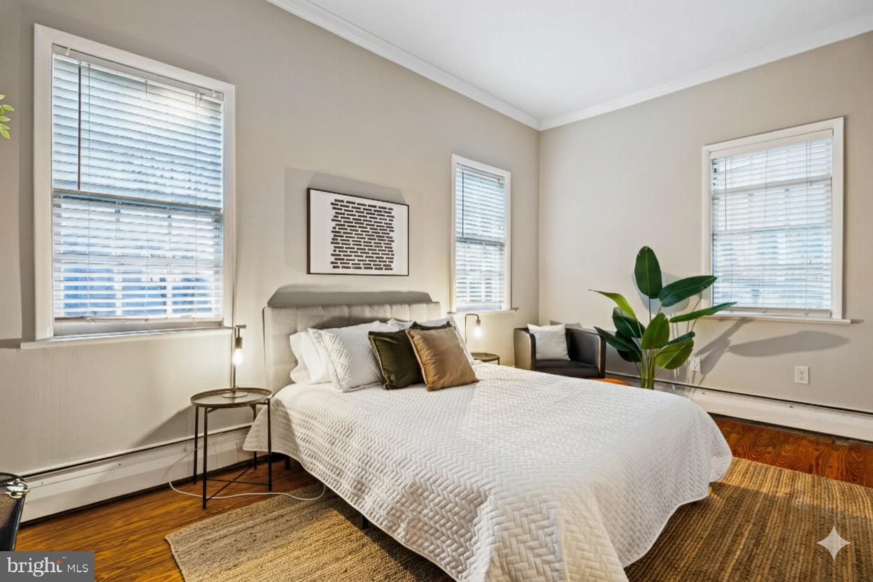 1238 Waverly Street Philadelphia, PA 19147 - Photo 8 of 24 a bedroom with a bed and a large window