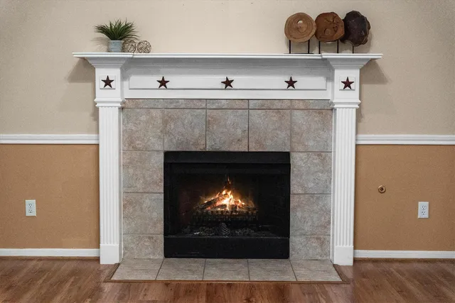 a room with a fireplace and wooden floor