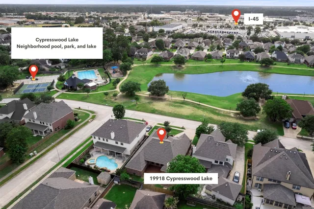 an aerial view of a tennis ground and a cars park side of the road