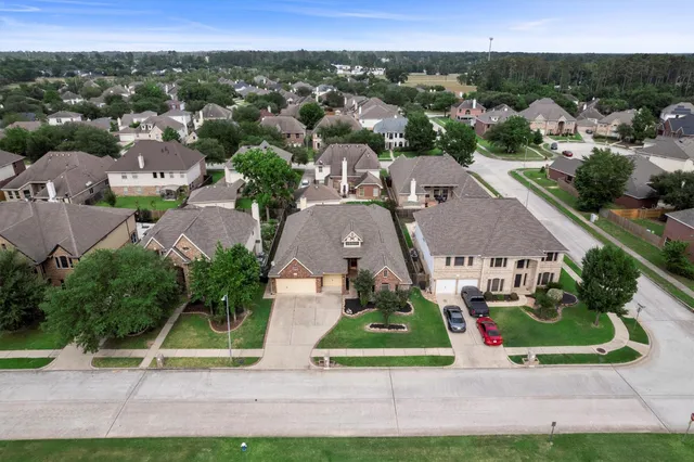 an aerial view of multiple houses with a yard
