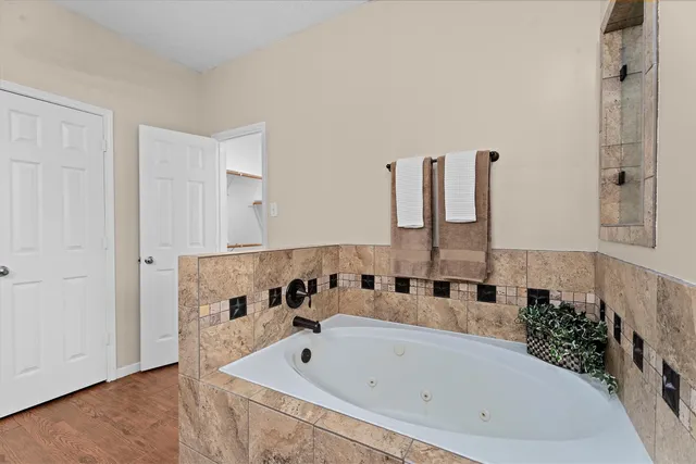 a bathroom with a tub and shower
