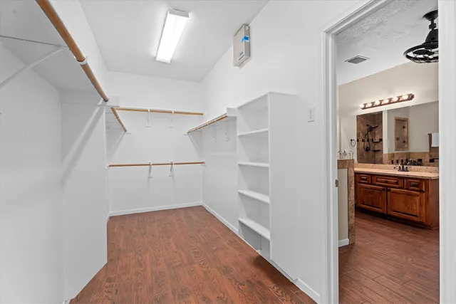 a view of a kitchen with a white cabinet and a stove top oven