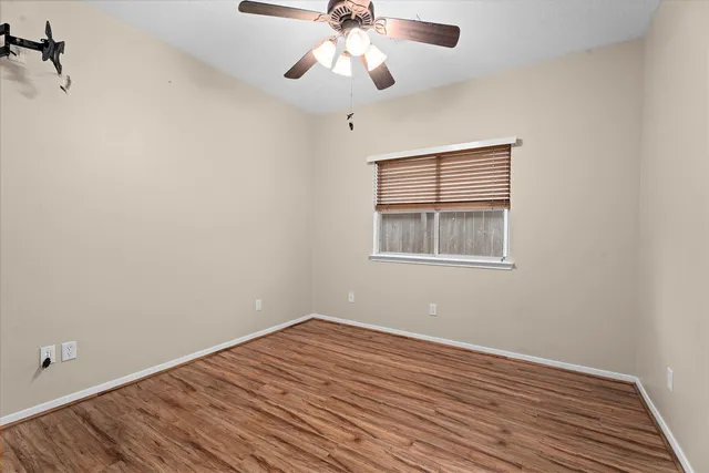 wooden floor in an empty room with a window