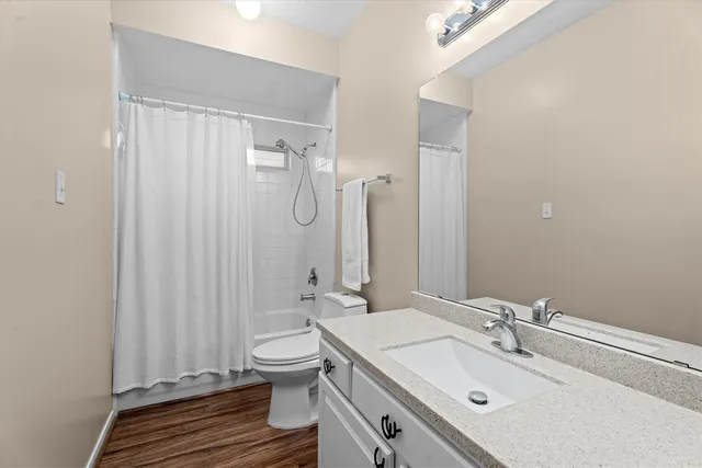 a bathroom with a sink toilet a mirror and shower