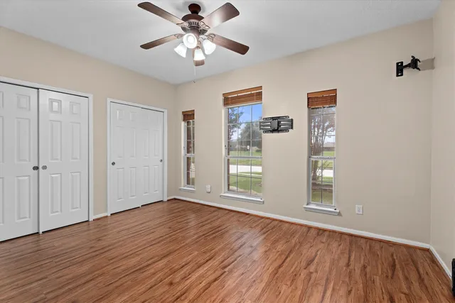 wooden floor in an empty room with a window