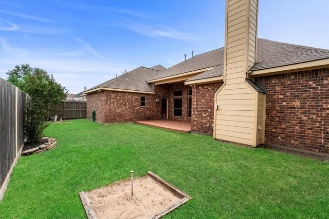 a view of a house with a backyard