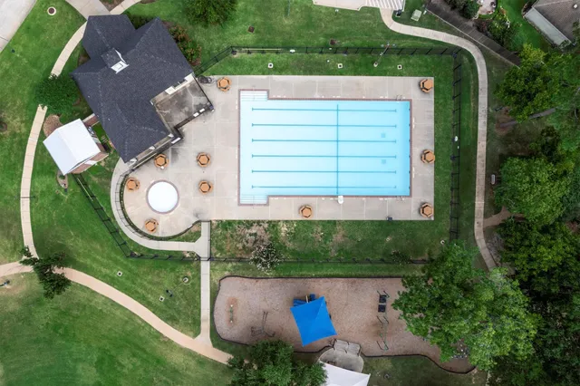 an aerial view of a house with garden space and street view