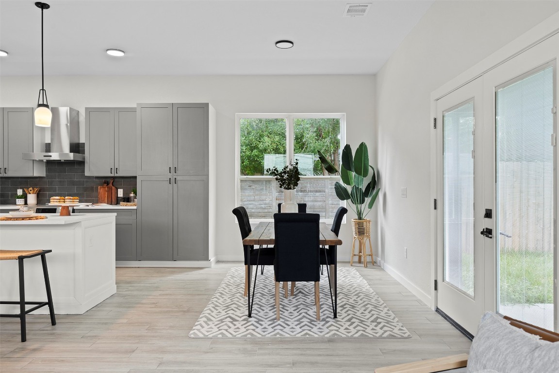 3611 Munson Street Austin, TX 78721 - Photo 14 of 40 a view of a dining room with furniture window and wooden floor