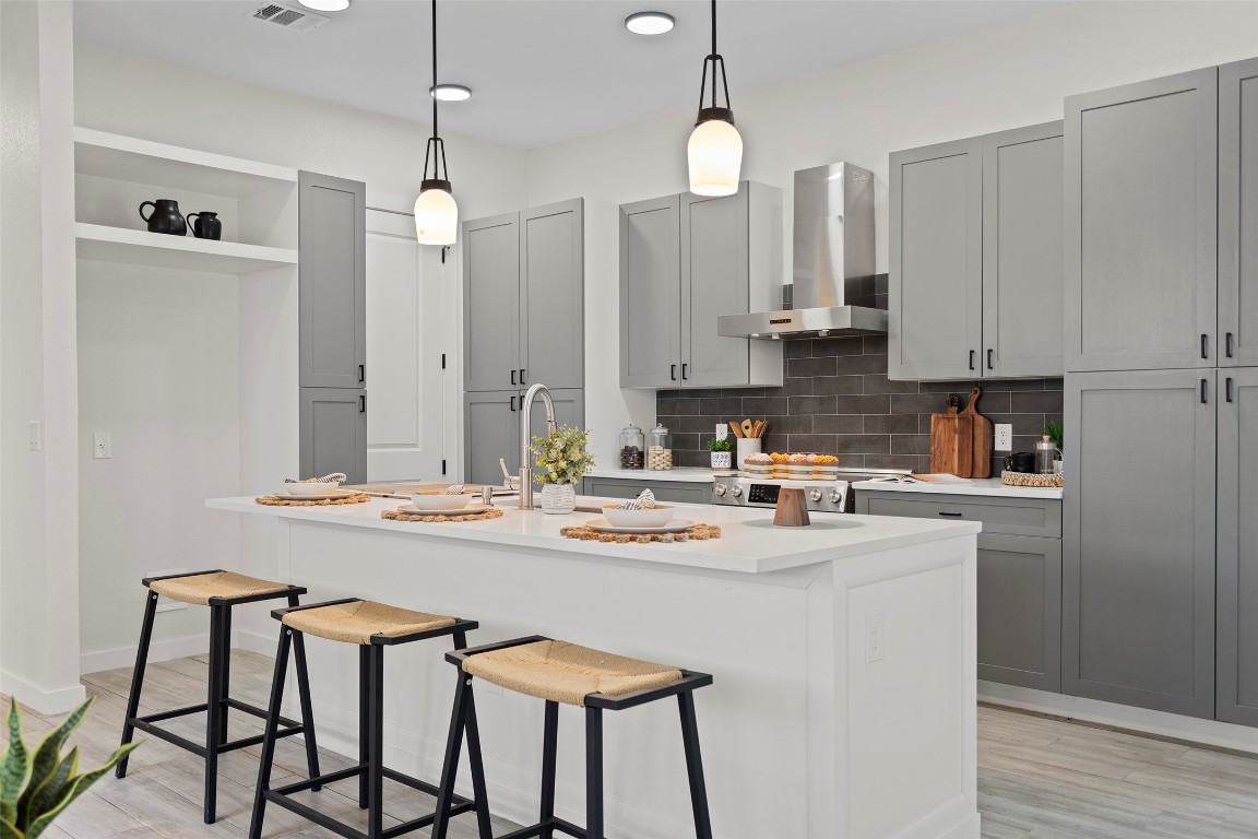 3611 Munson Street Austin, TX 78721 - Photo 15 of 40 a kitchen with stainless steel appliances stove refrigerator and cabinets