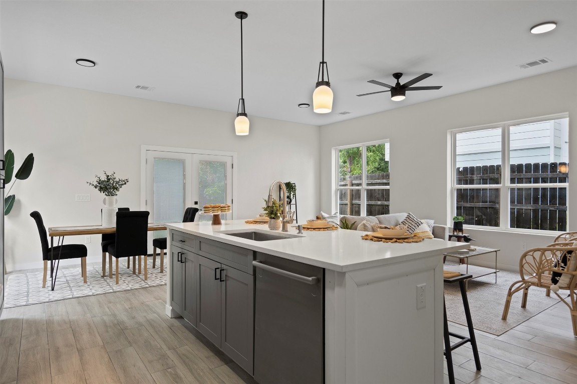 3611 Munson Street Austin, TX 78721 - Photo 19 of 40 a view of a dining room and livingroom with furniture wooden floor a chandelier