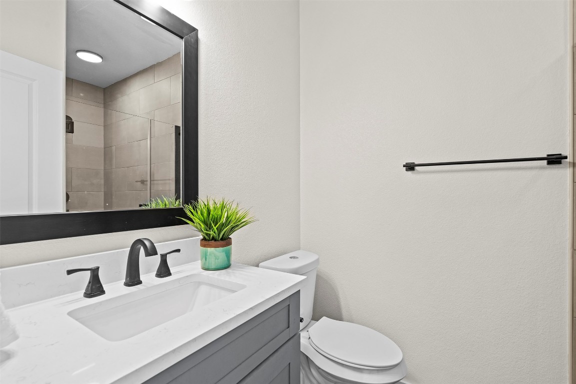 3611 Munson Street Austin, TX 78721 - Photo 32 of 40 a bathroom with a sink and a mirror