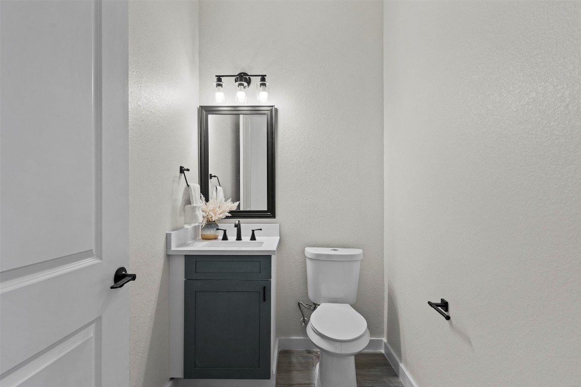 3611 Munson Street Austin, TX 78721 - Photo 7 of 40 a bathroom with a sink toilet and mirror