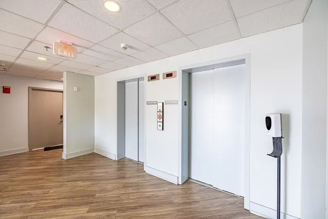 a living room with fireplace furniture and a wooden floor