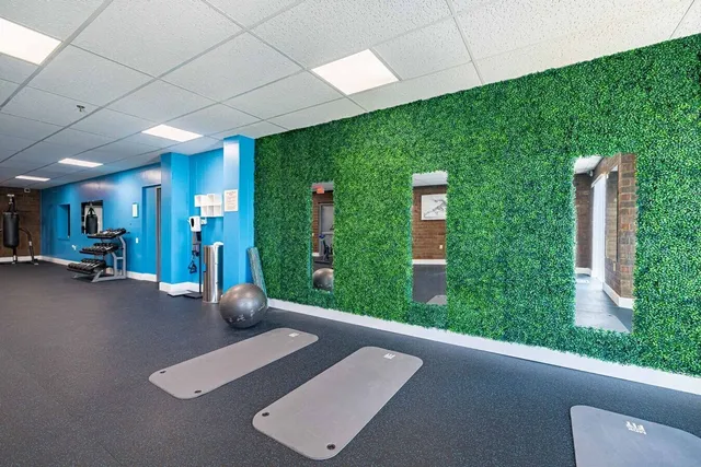 a view of entryway with a rug and a floor to ceiling window