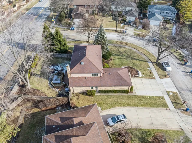 an aerial view of a house with garden space and street view