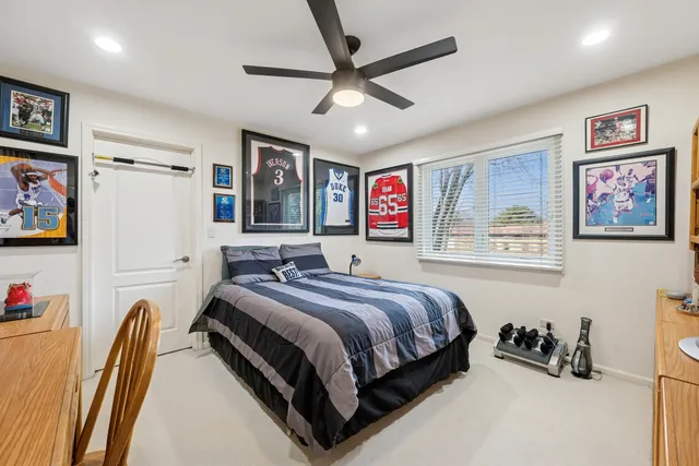 a bedroom with a bed and a large mirror