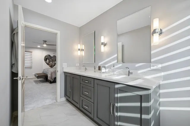 a en suite bathroom with double sink and a mirror