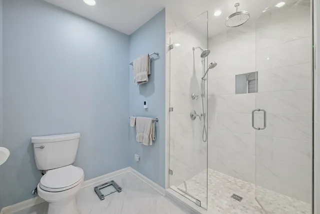 a bathroom with a toilet sink and shower