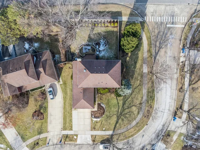 a front view of a house with a yard and fountain