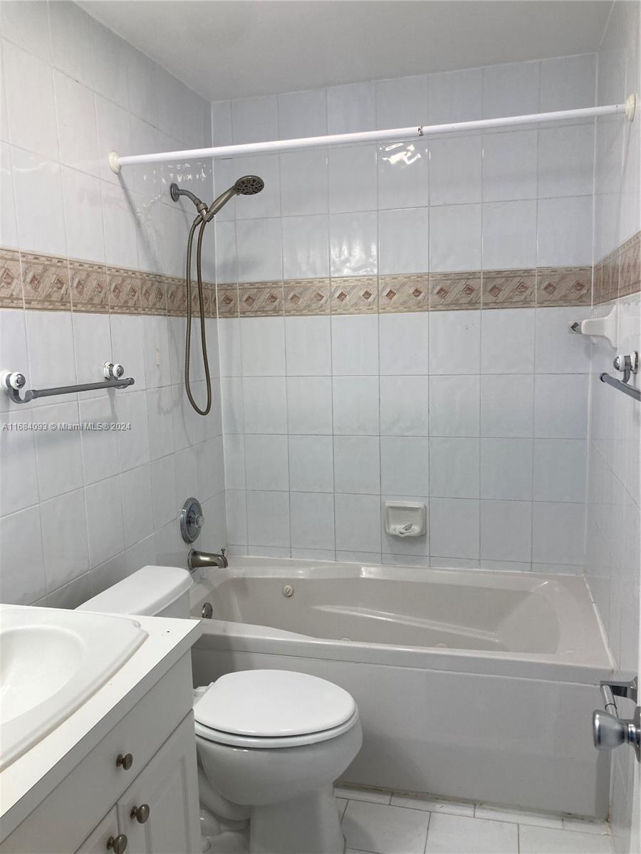 13731 Southwest 84th Street, Unit E Miami, FL 33143 - Photo 17 of 19 a bathroom with a sink a toilet and a bathtub
