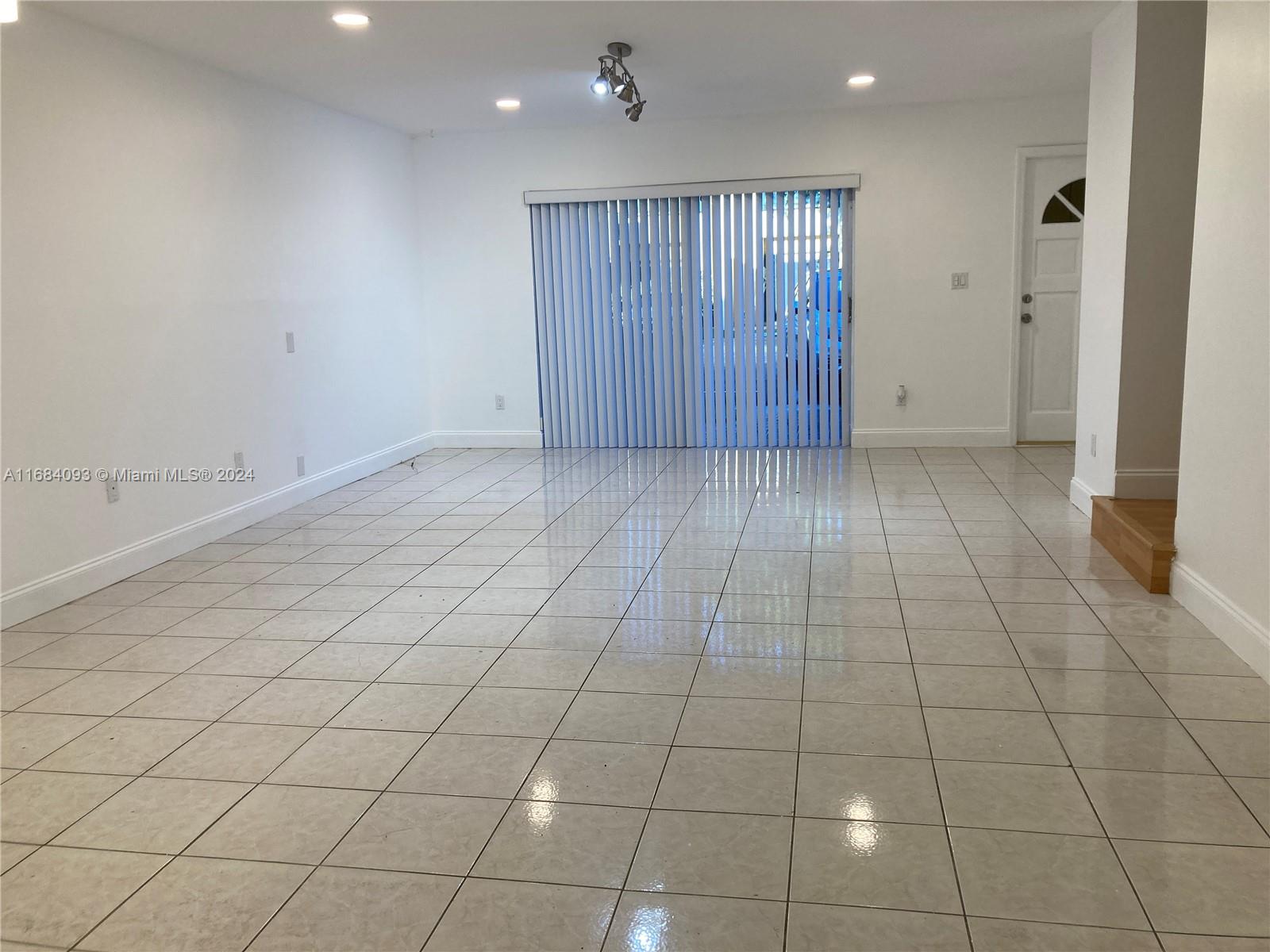 13731 Southwest 84th Street, Unit E Miami, FL 33143 - Photo 2 of 19 an empty room with windows