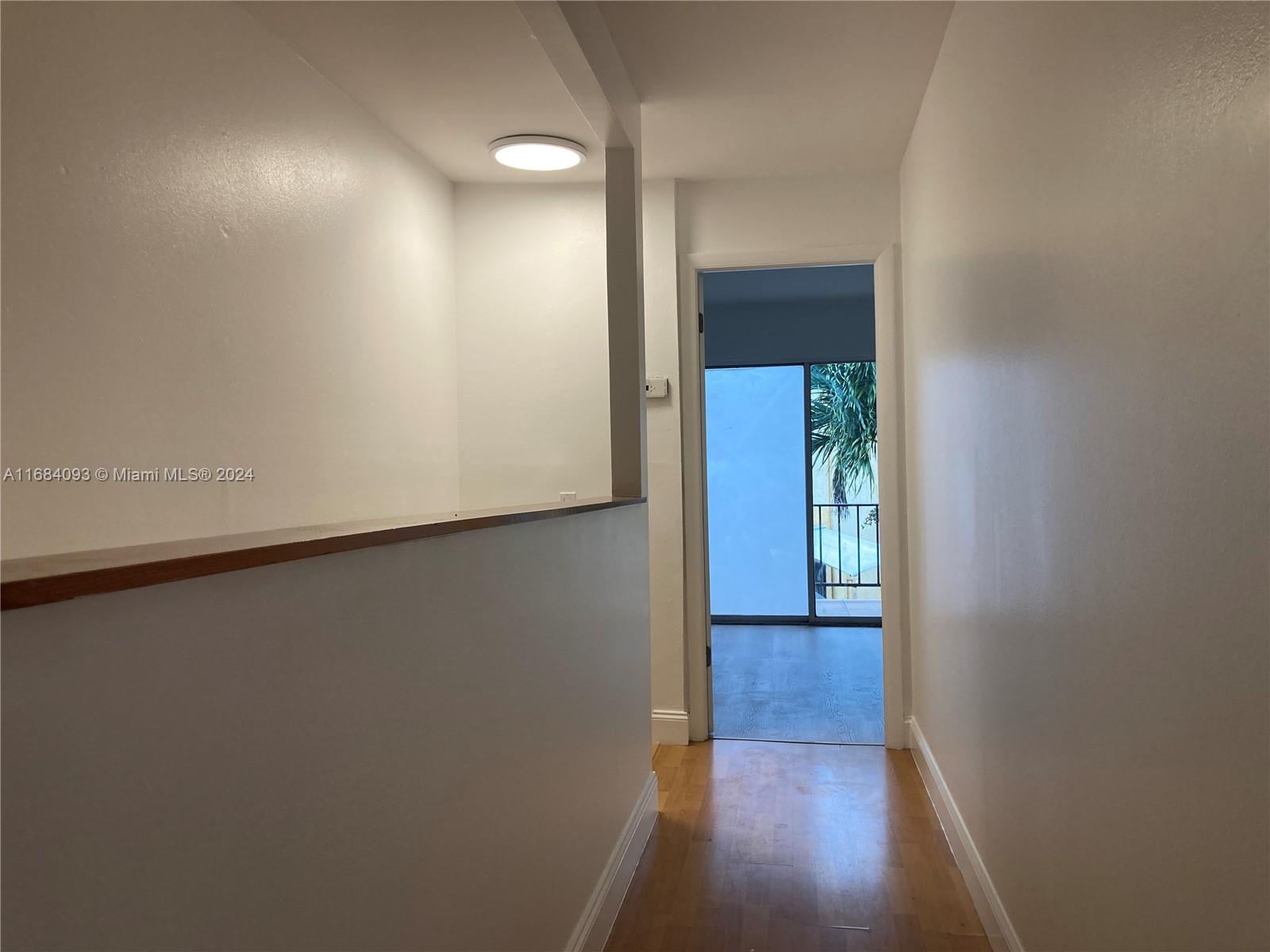 13731 Southwest 84th Street, Unit E Miami, FL 33143 - Photo 7 of 19 a view of a hallway with wooden floor