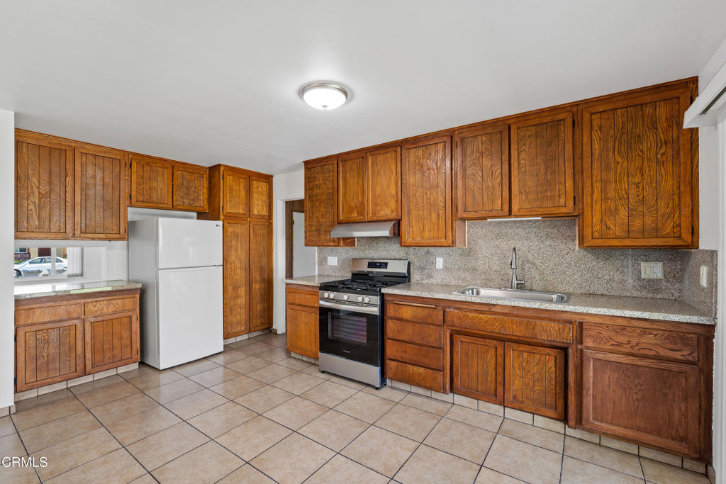 1511 Fathom Drive Oxnard, CA 93035 - Photo 8 of 29 a kitchen with cabinets and white appliances
