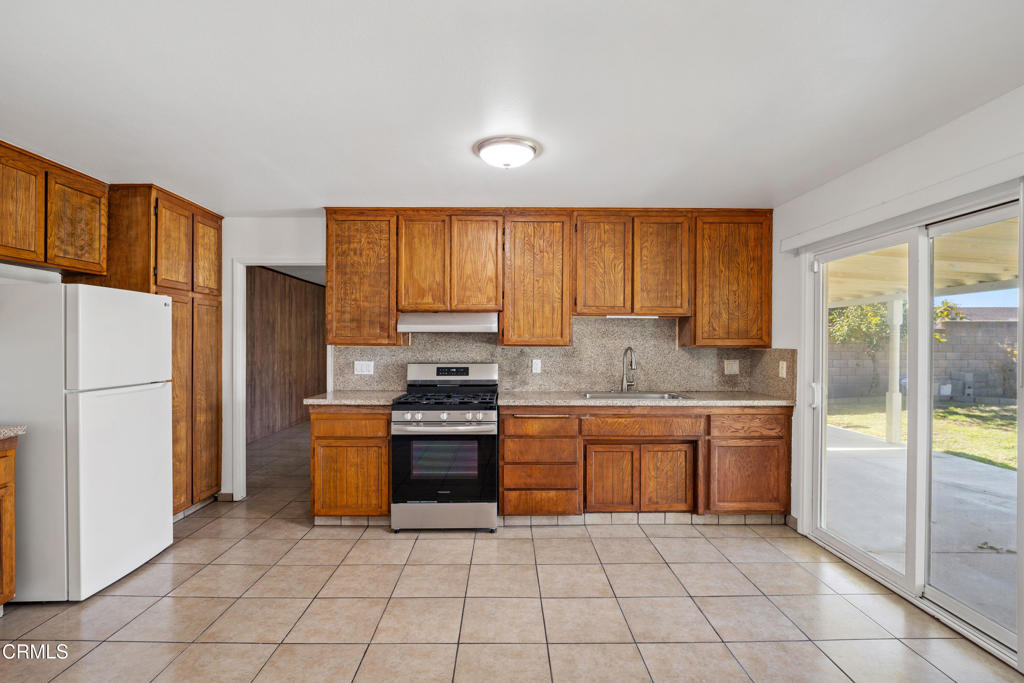 1511 Fathom Drive Oxnard, CA 93035 - Photo 10 of 29 a kitchen with stainless steel appliances granite countertop a refrigerator stove and sink
