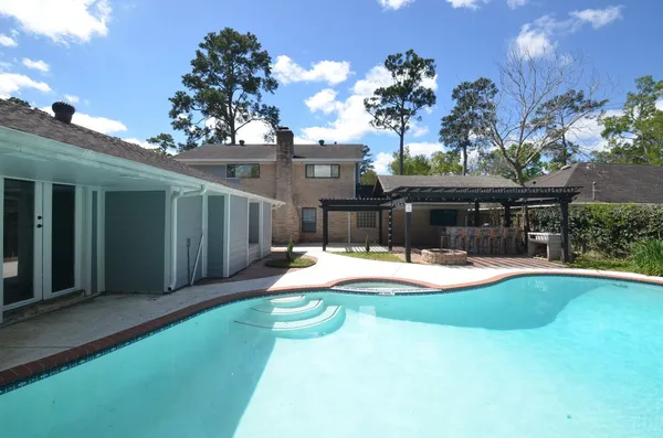 a view of a house with swimming pool and sitting area