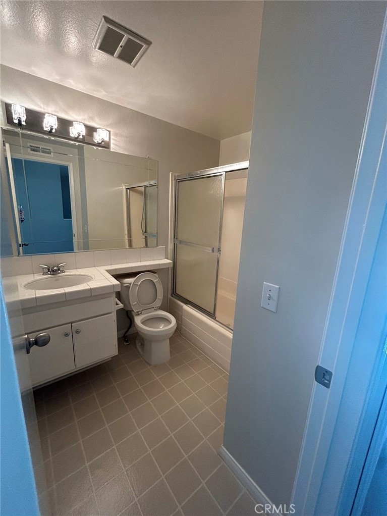 37 Butterfield Irvine, CA 92604 - Photo 8 of 9 a bathroom with a double vanity sink mirror and toilet