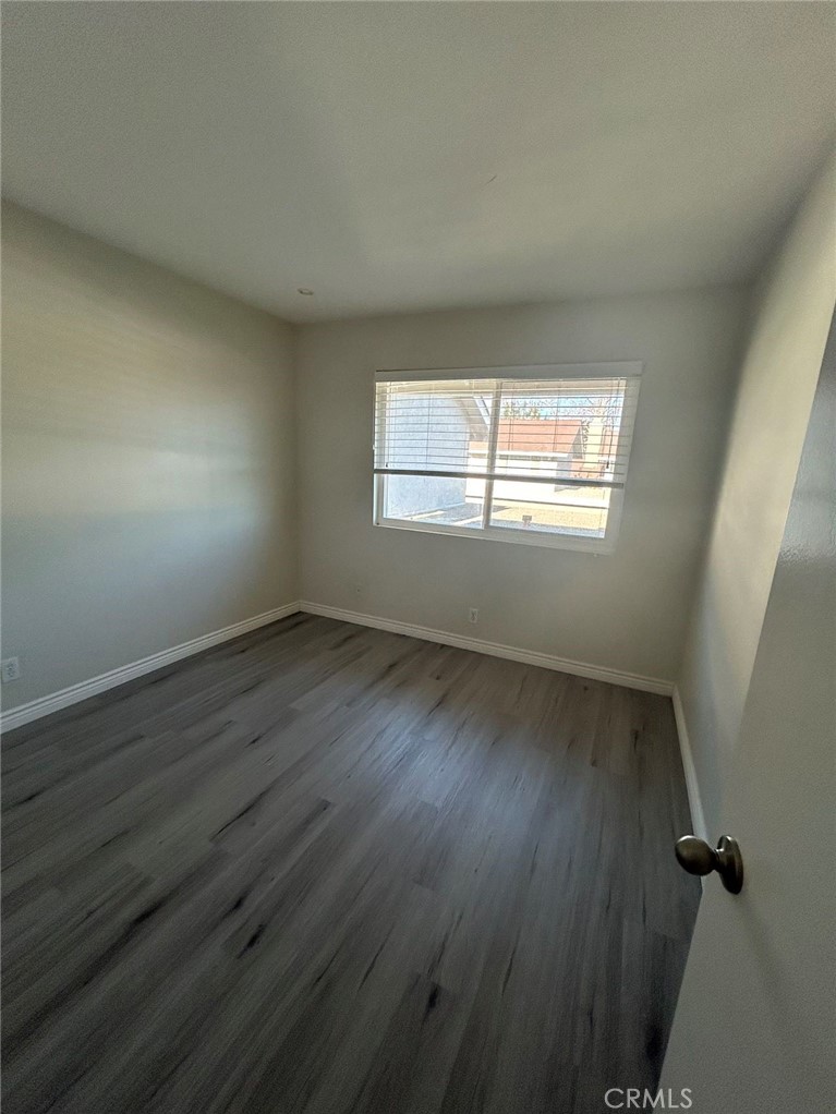 37 Butterfield Irvine, CA 92604 - Photo 9 of 9 an empty room with wooden floor and windows