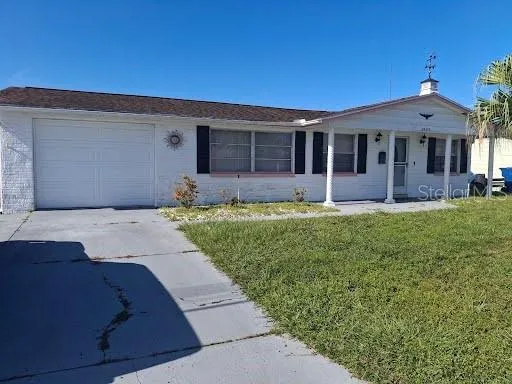 a front view of a house with a garden and yard