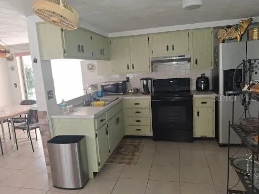 a kitchen with cabinets and appliances